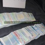 Hundreds of fake id cards laid out in two rows made by IDGod.